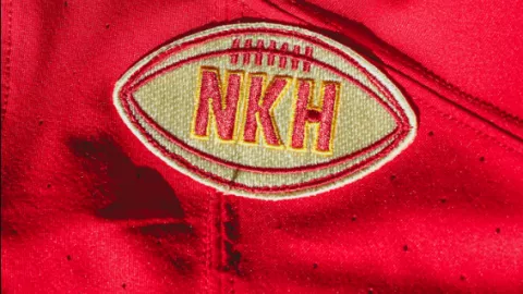 Parche con forma de balón y las iniciales NKH