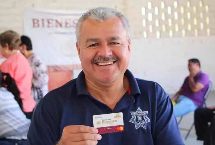 hombre sostiene su Tarjeta del Bienestar