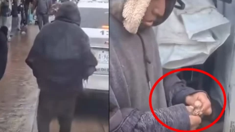 Indigente comiendo rata