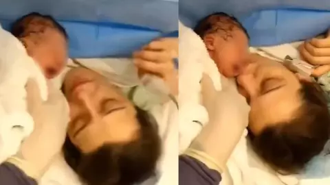 Recién nacido reacciona a beso de su madre.