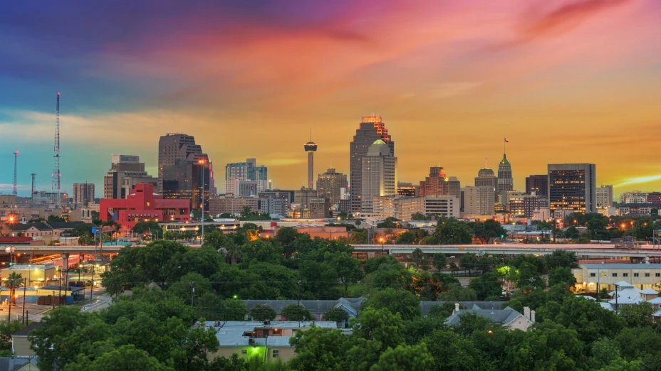 Avistaje panorámico de la ciudad de San Antonio, Texas, con la puesta del sol detrás de los edificios