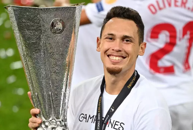 Lucas Ocampos sosteniendo el trofeo de la UEL
