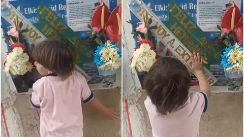 niño visita la tumba de su padre