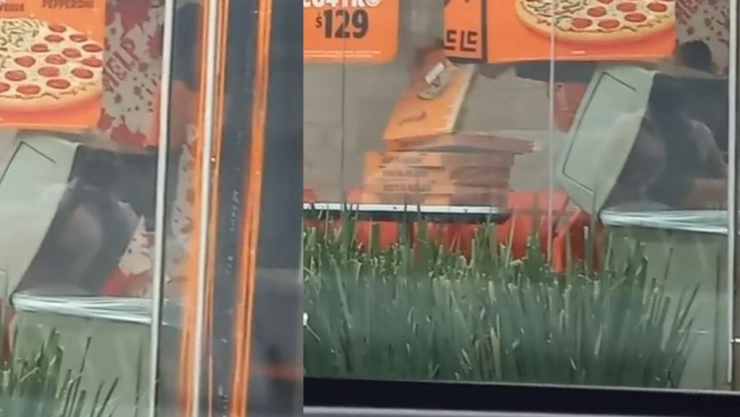 Captan a empleado de pizzeria sacando cajas de la basura.