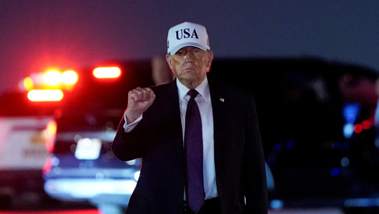 El presidente de Estados Unidos, Donald Trump, levanta el puño tras desembarcar del Air Force One en el Aeropuerto Internacional de Palm Beach en West Palm Beach, Florida, EE. UU., el 27 de febrero de 2026.