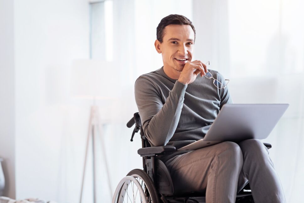 Positive delighted disabled man looking forward