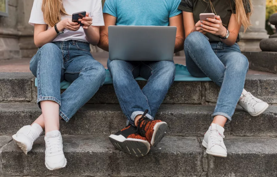 teens-sitting-stairs-working-phones-laptop.jpg