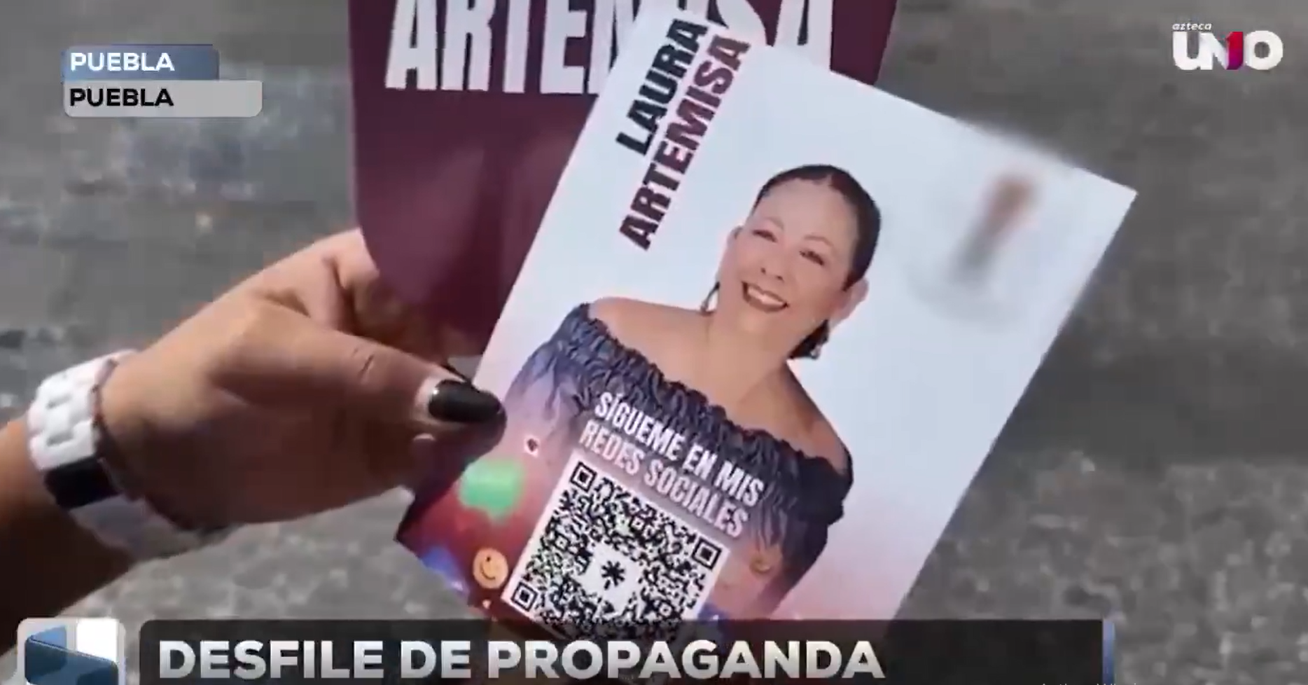 ¡Desfile del 5 de Mayo en Puebla se convirtió en un acto anticipado de campaña! Ciudadanos reportaron la entrega de artículos promocionales de funcionarios del partido de Morena, en donde el nombre y rostro de Laura Artemisa, secretaria de Bienestar, se vio en sombrillas y hasta loterías.
